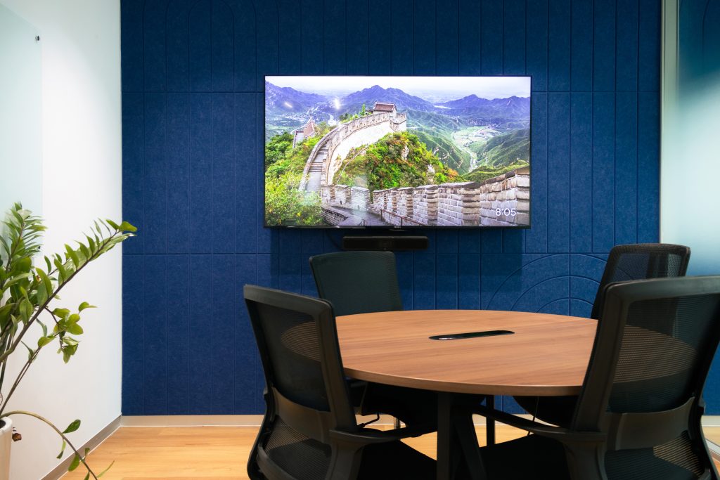 Acoustic panel wall with linear groove design improving acoustics in office space