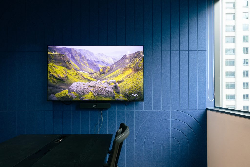 Acoustic panel wall with linear groove design improving acoustics in Singapore office space