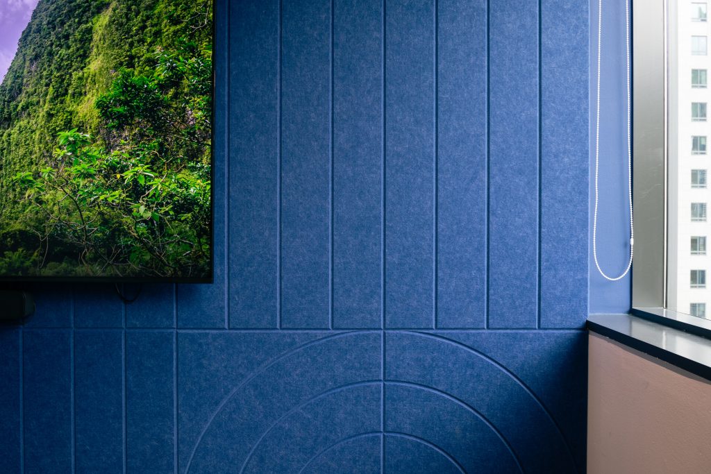 acoustic wall panels with V-groove pattern managing sound reflections in meeting room