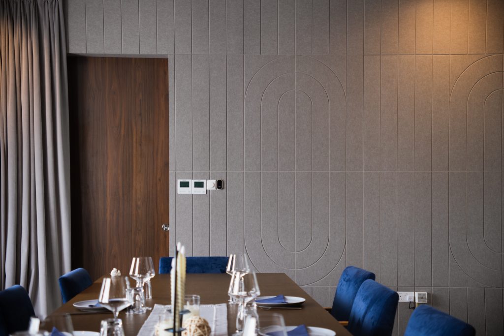 Grooved acoustic panels installed on restaurant wall for sound absorption and visual texture