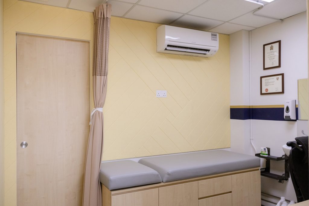 Yellow acoustic wall panels in herringbone pattern improving sound absorption in clinic interior