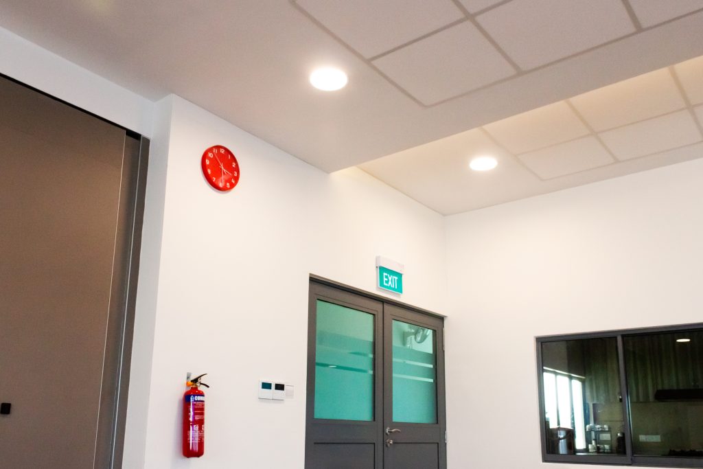 Acoustic panel ceiling installation in Singapore church space with integrated lighting layout