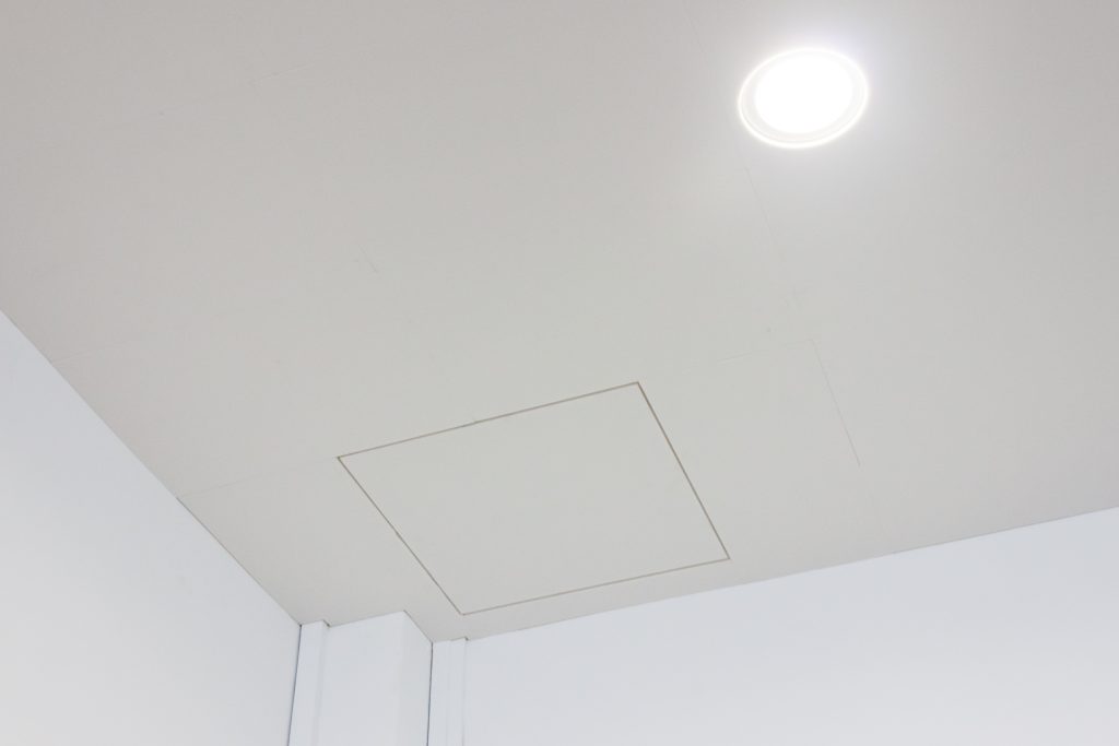 Acoustic ceiling panels installed across large worship hall for sound reflection control