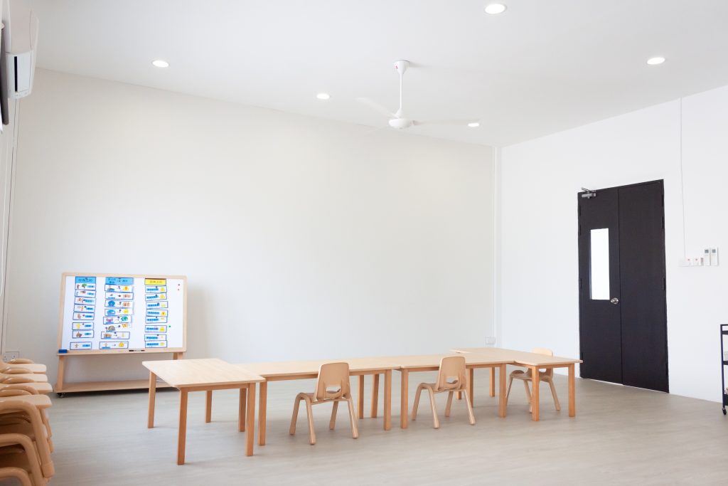 Acoustic panels integrated seamlessly into white ceiling and wall surfaces in church interio