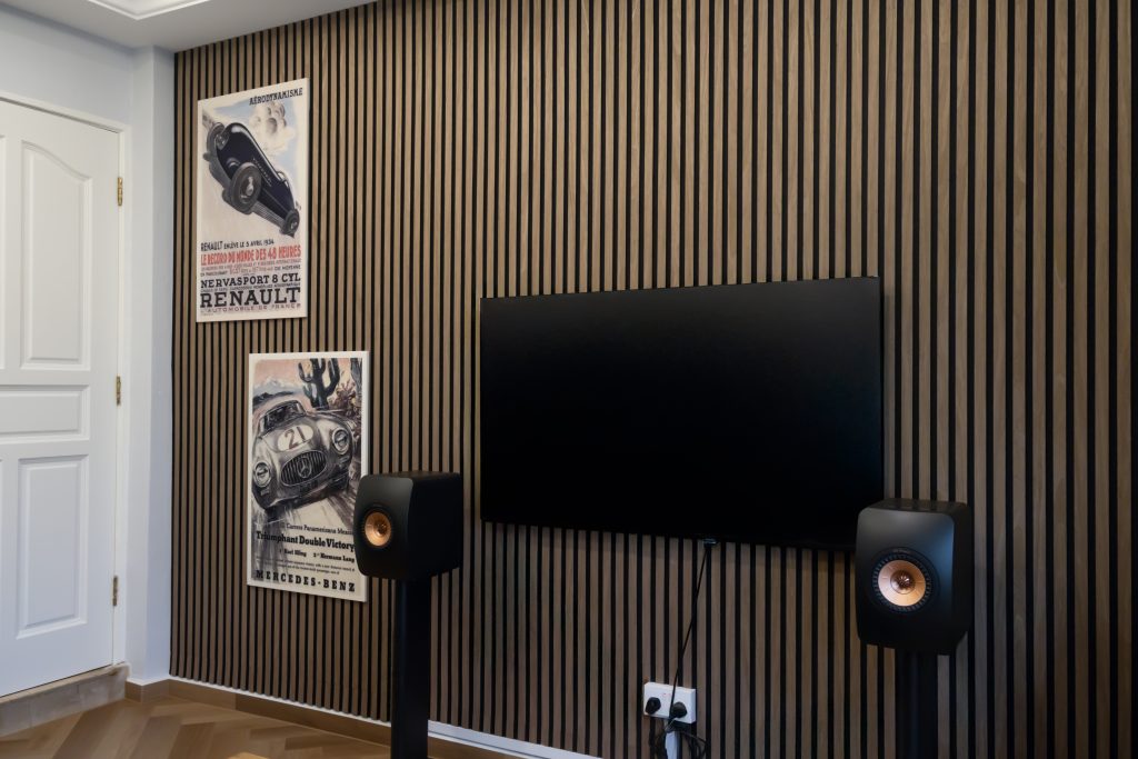 Vertical slat acoustic panels in SD03 Walnut managing sound reflections in home music room