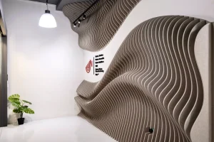 Wave Wall acoustic panels covering the main entrance wall of a commercial office in Singapore