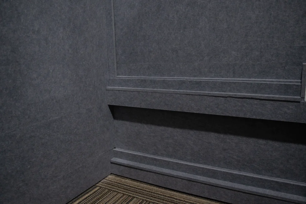 Corner junction and skirting detail of Klar™ Essentials acoustic panels at Weave Pte Ltd office Singapore