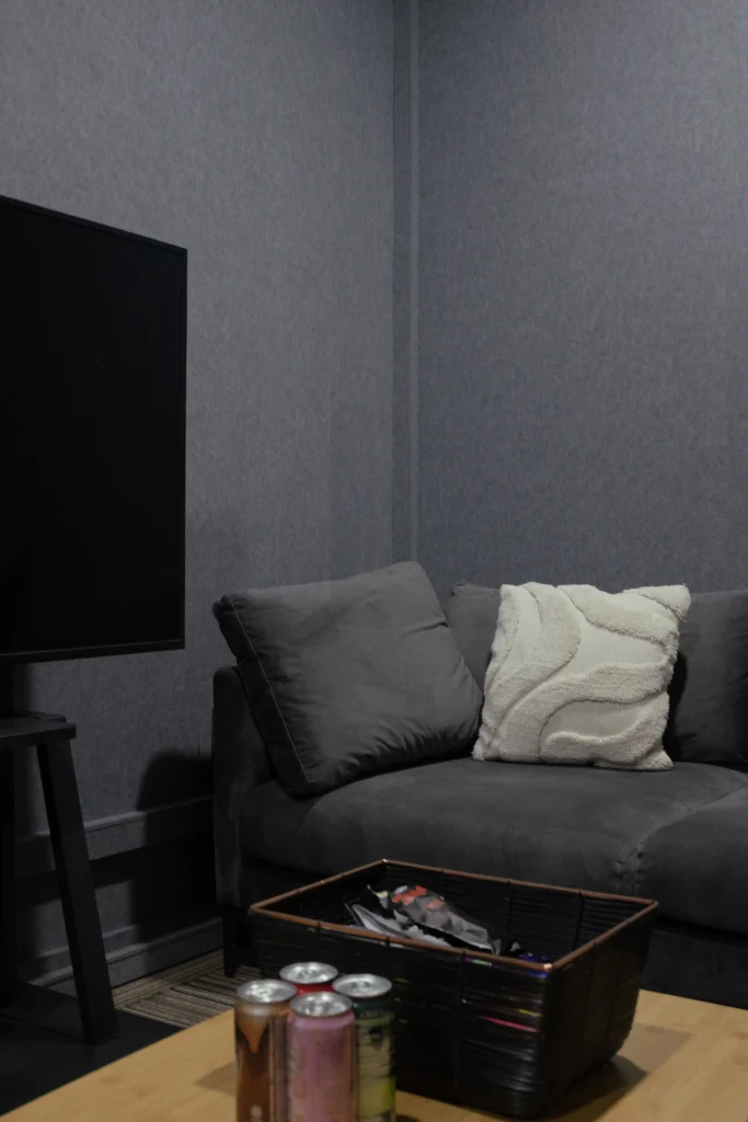 Klar™ Essentials acoustic panels wrapping corner walls of Weave Pte Ltd office Singapore with sofa and TV