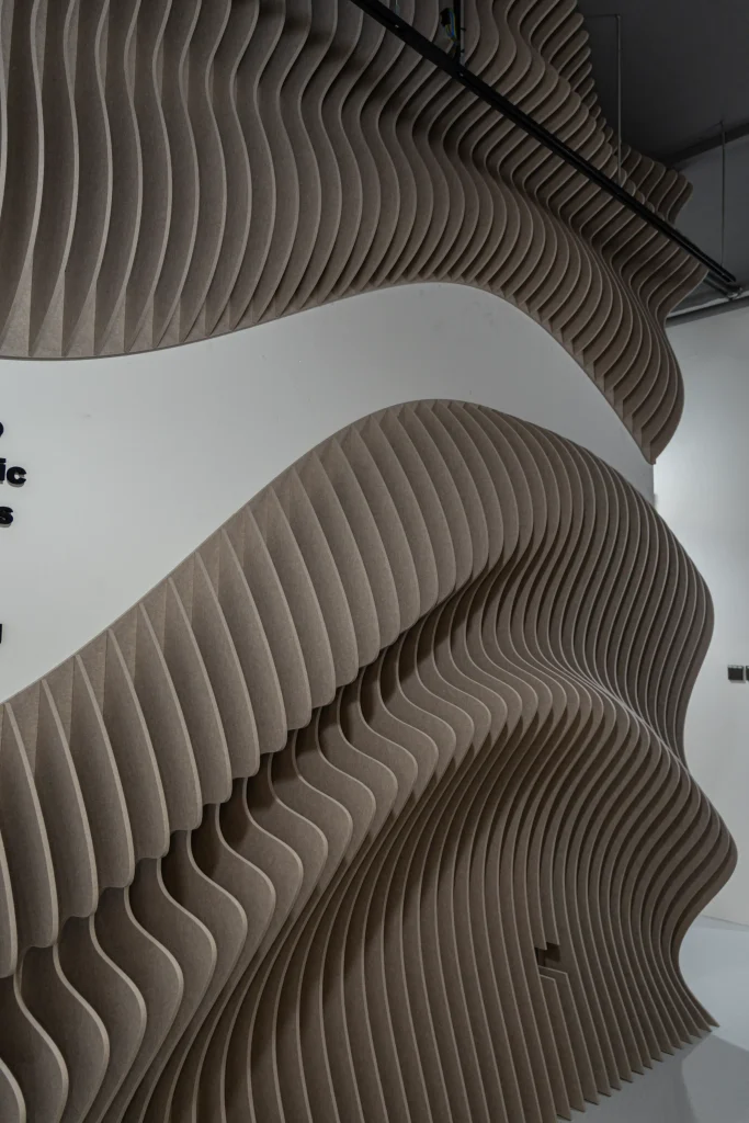 Klar Wave Wall acoustic panels installed across the ceiling of Union Noise Group office entrance in Singapore