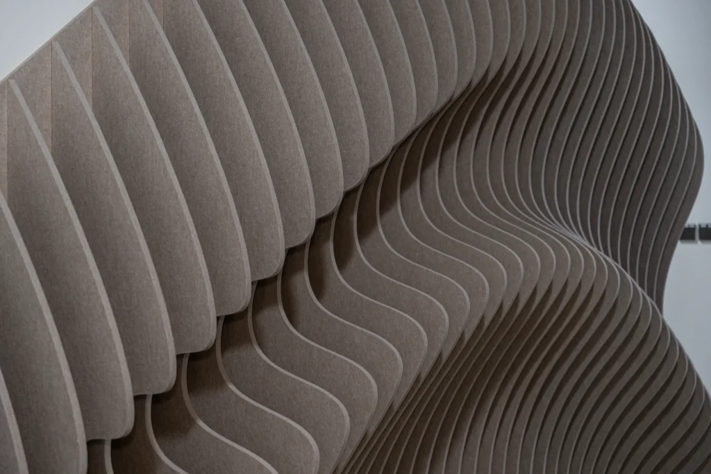 Close-up of Klar Wave Wall acoustic panel in Latte CM10 showing layered PET felt texture and wave profile