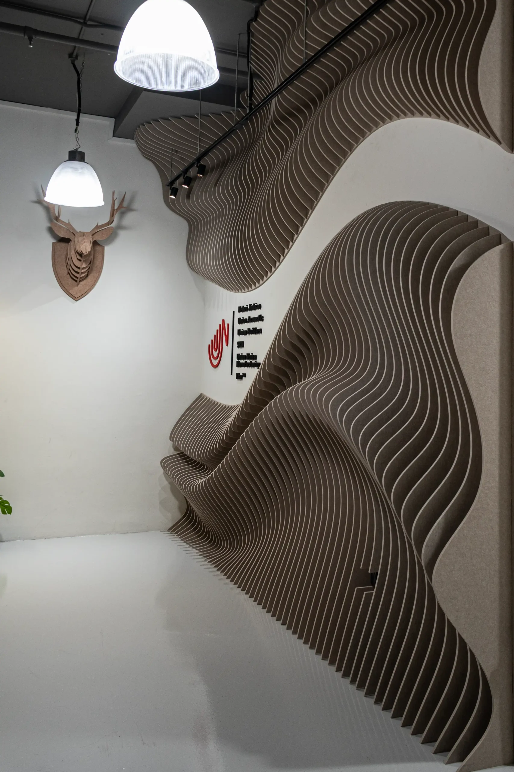 Wave Wall acoustic panels covering the main entrance wall of a commercial office in Singapore