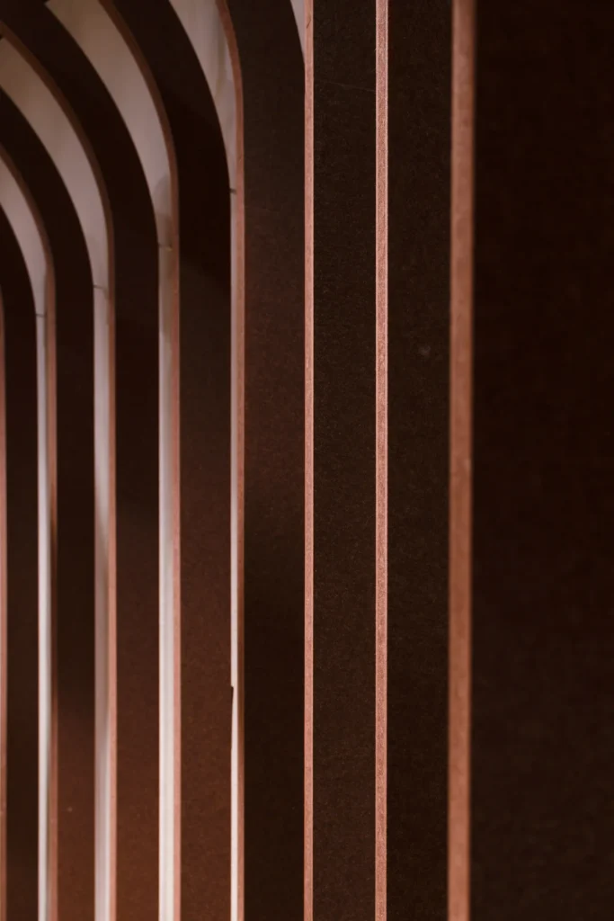 Close-up of Klar™ acoustic panel pillars with copper-toned edges in the Marine Parade community space